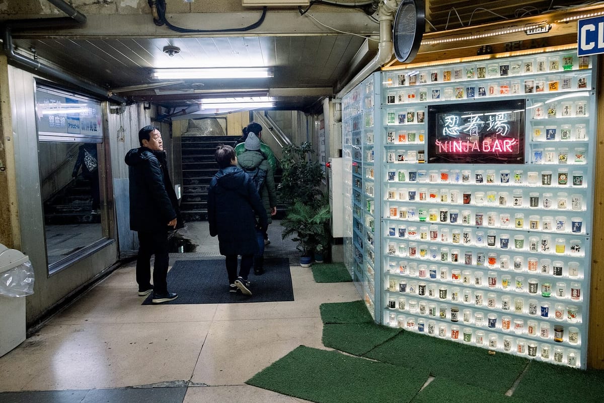 The narrow passage of the Asakusa Underground Street with small shop signs on both sides
